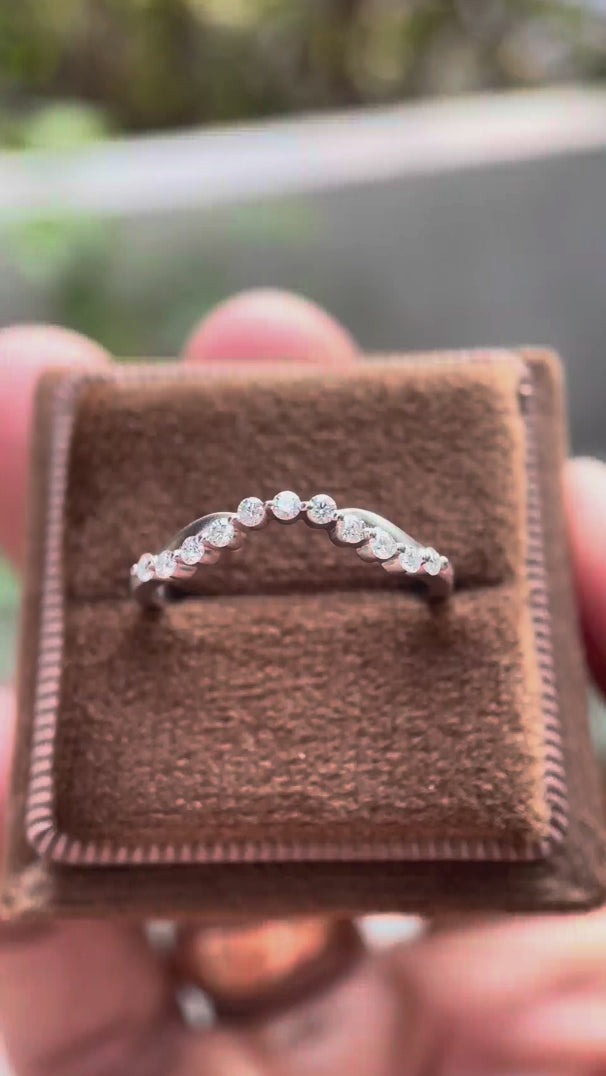 Rotating view of curved bubble prong half eternity wedding band in matte white gold