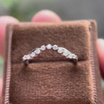 Rotating view of curved bubble prong half eternity wedding band in matte white gold