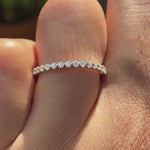 Video of bubble floating shared prong eternity wedding band worn on hand