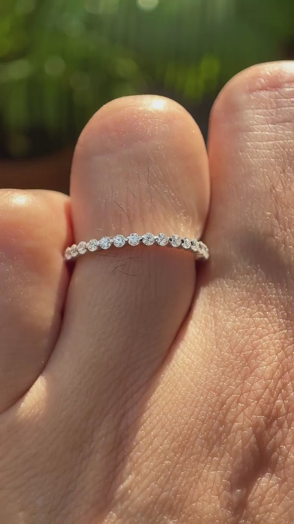 Video of bubble floating shared prong eternity wedding band worn on hand