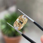 Elongated cushion light champagne moissanite Old Mine Cut rotating view showcasing facet brilliance