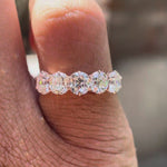 Rotating video showing five elongated cushion moissanites in rose gold band