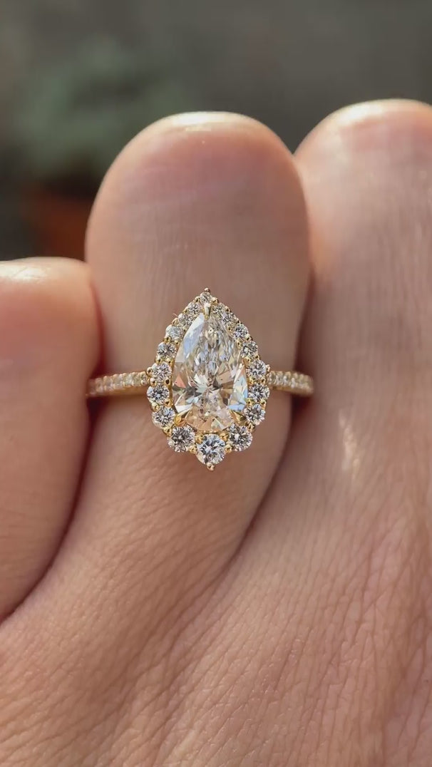 Pear cut lab grown diamond halo engagement ring shown in rotating video
