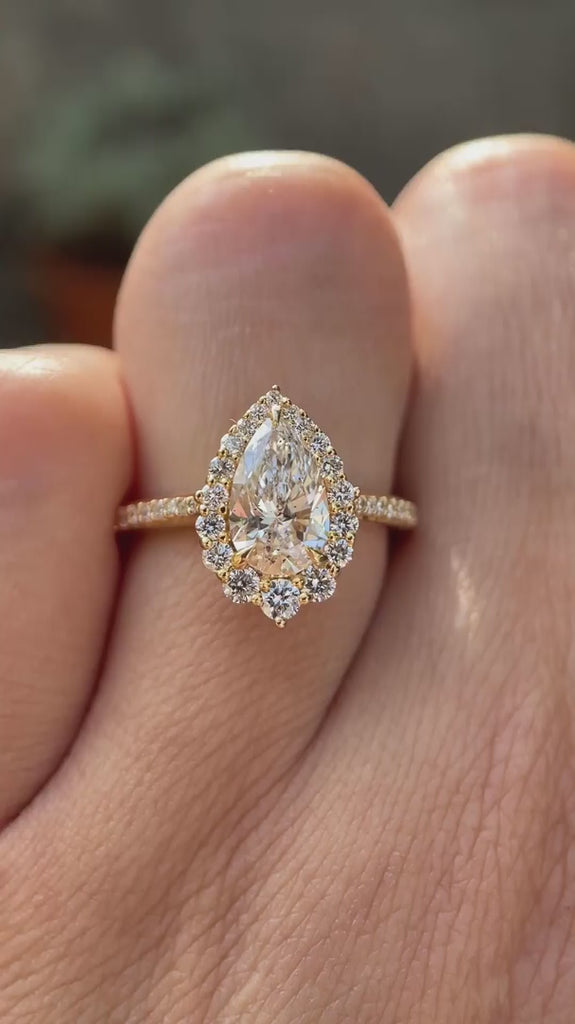 Pear cut lab grown diamond halo engagement ring shown in rotating video