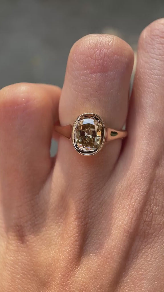 Minimalist signet style moissanite engagement ring on hand video