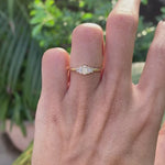 Rotating video showing bar set five stone baguette moissanite gold ring.