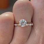 Round cut lab grown diamond engagement ring with diamond accented band in 14K yellow gold rotating view