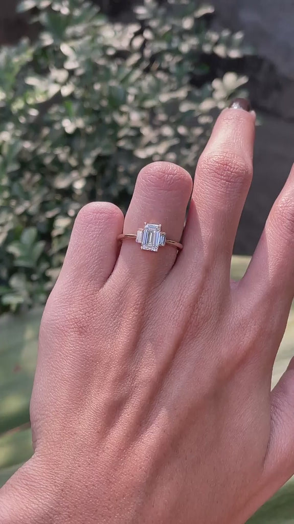 Emerald cut three stone engagement ring in 10k yellow gold on hand video