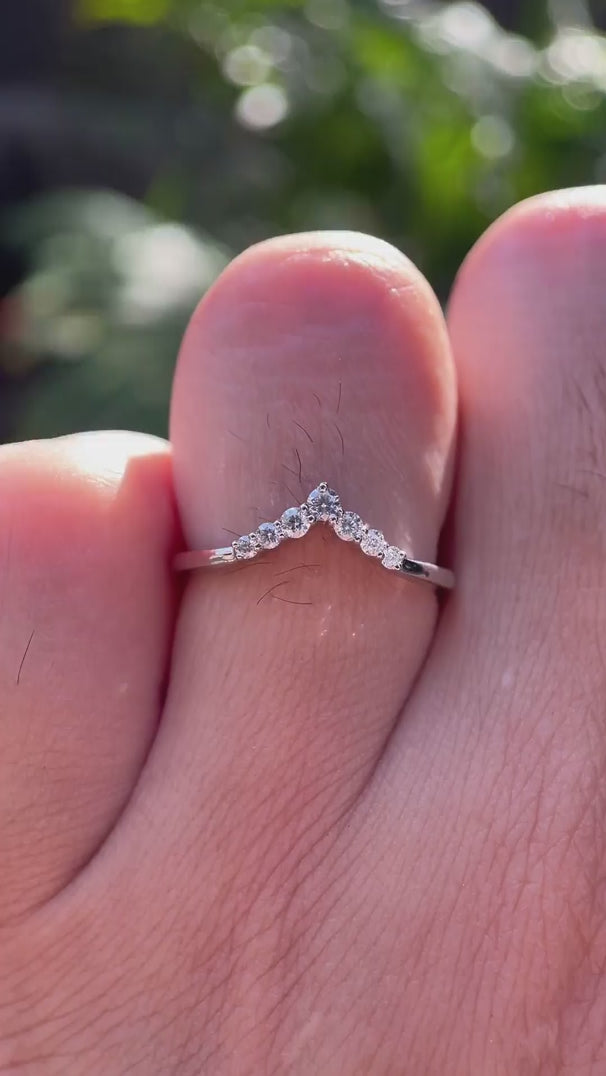 Rotating view of chevron moissanite wedding band sparkling in white gold