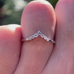 Rotating view of chevron moissanite wedding band sparkling in white gold