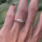 Delicate three stone engagement ring on hand yellow gold video