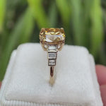 Elongated cushion old mine cut dark champagne moissanite ring with baguette side stones shown from multiple angles