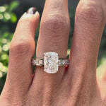 Rotating view elongated cushion lab diamond ring with channel set band.