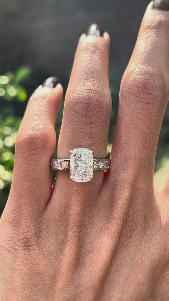 Rotating view elongated cushion lab diamond ring with channel set band.