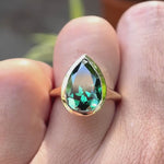 Pear old mine cut dark green moissanite bezel solitaire signet ring in 10K yellow gold shown in rotating video