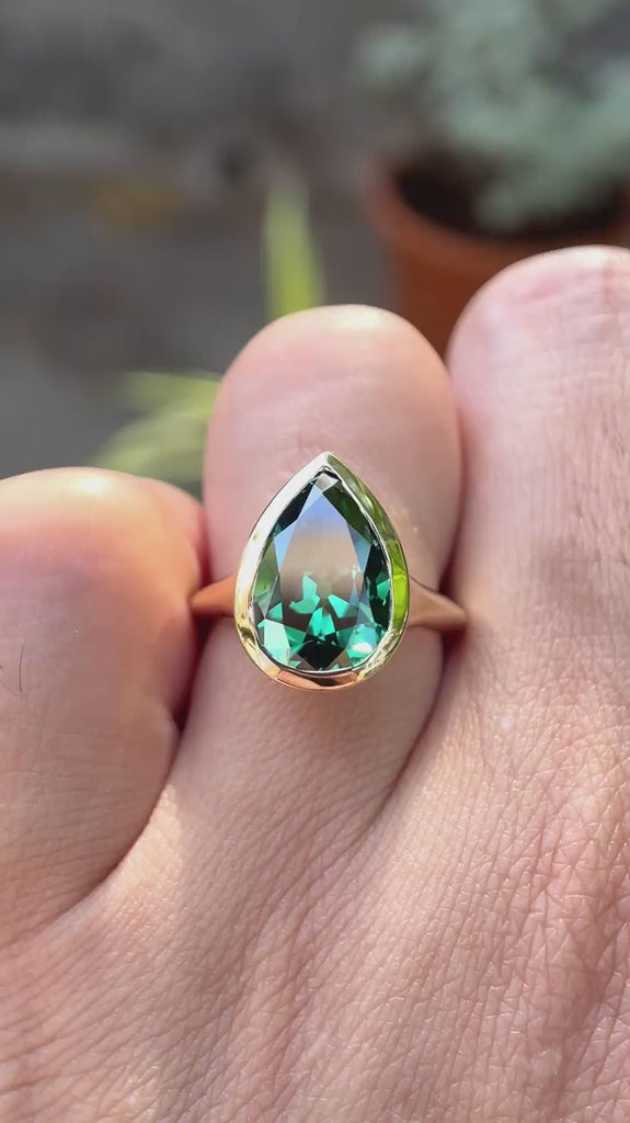 Pear old mine cut dark green moissanite bezel solitaire signet ring in 10K yellow gold shown in rotating video