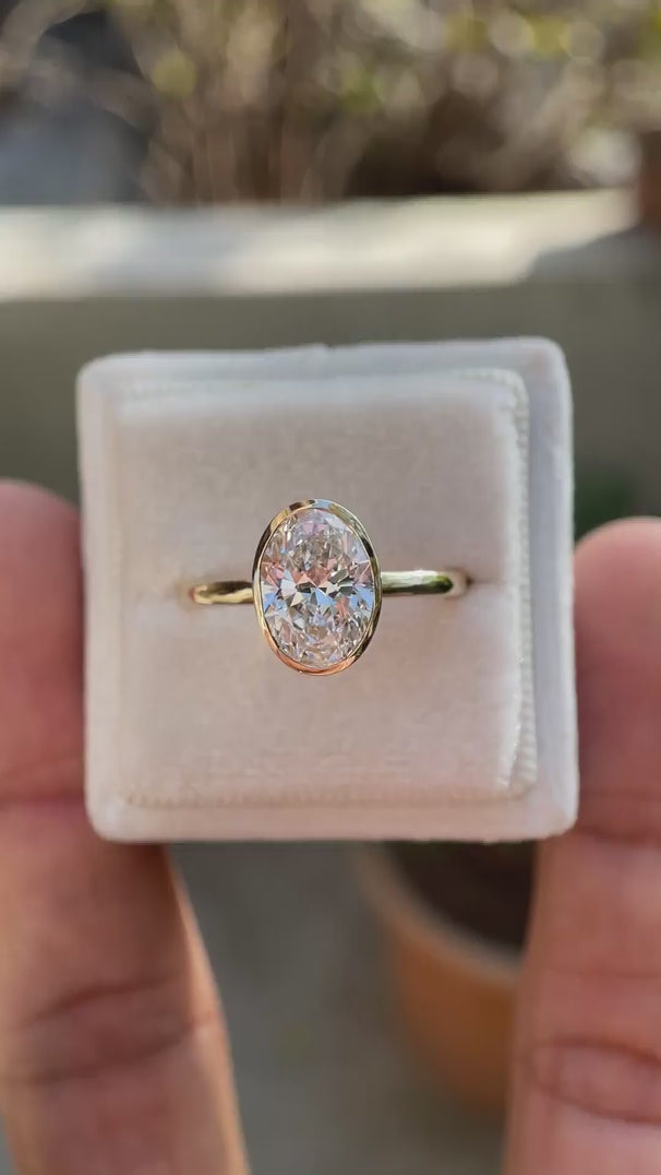 oval moissanite solitaire ring with smooth gold bezel video