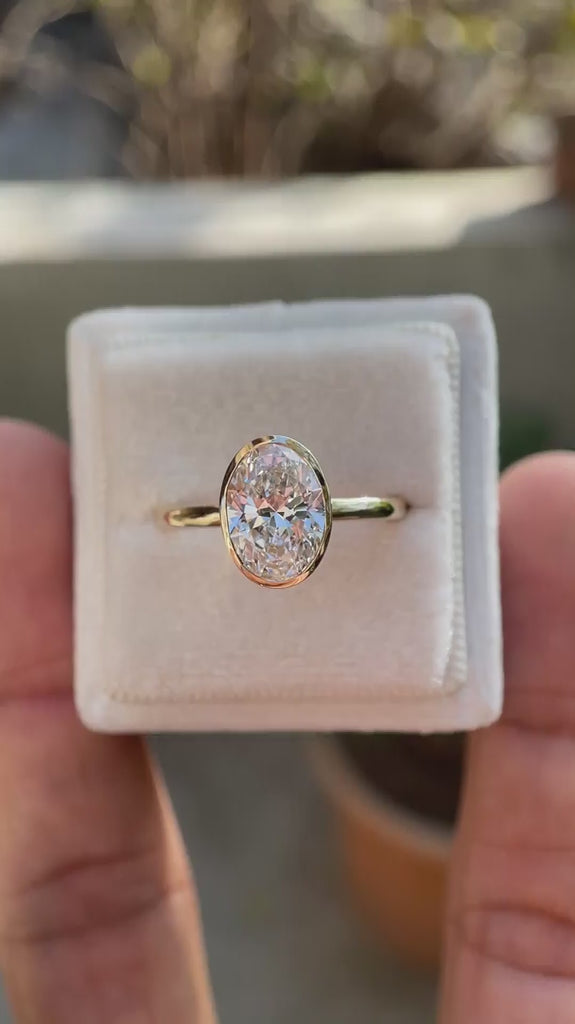 oval moissanite solitaire ring with smooth gold bezel video