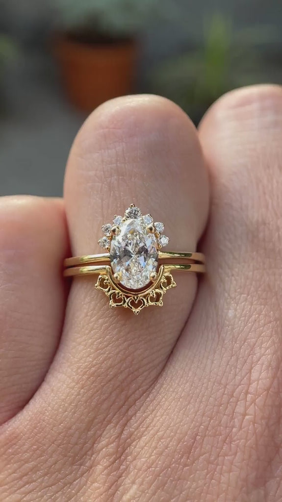 Oval lab grown diamond cluster engagement ring set in 14K yellow gold shown from multiple angles