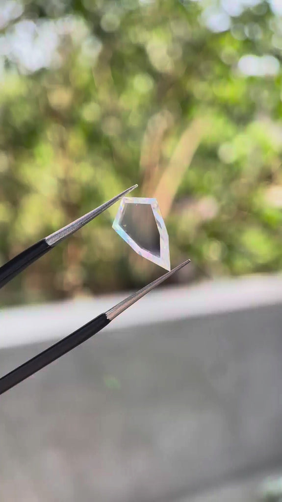 Shield portrait cut moissanite gemstone showcasing clean transparency and geometric silhouette