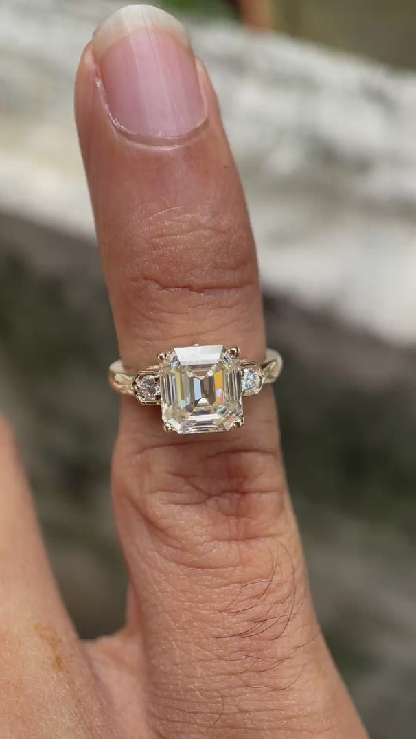 Video showing the three-stone Moissanite engagement ring from all angles in 10K yellow gold.