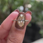 Rotating oval champagne bezel ring  showing side profile and sparkle