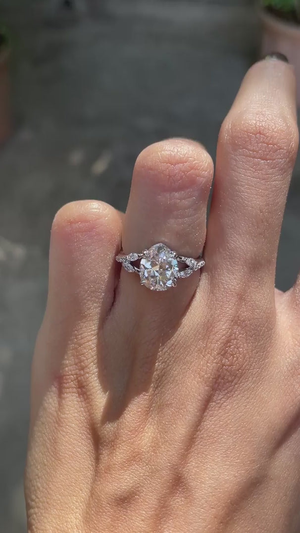 Pear moissanite platinum engagement ring, split shank, marquise and round accents