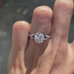 Pear moissanite platinum engagement ring, split shank, marquise and round accents