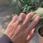 cushion halo engagement ring with round diamond accents on finger video 