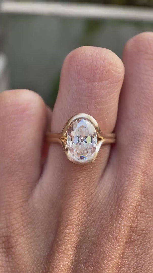 Matte yellow gold oval moissanite half bezel ring video