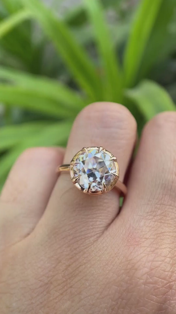 Rotating view of solitaire ring showing front, side, and setting details