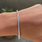 Rotating view of graduating lab grown diamond bangle bracelet with seamless lock