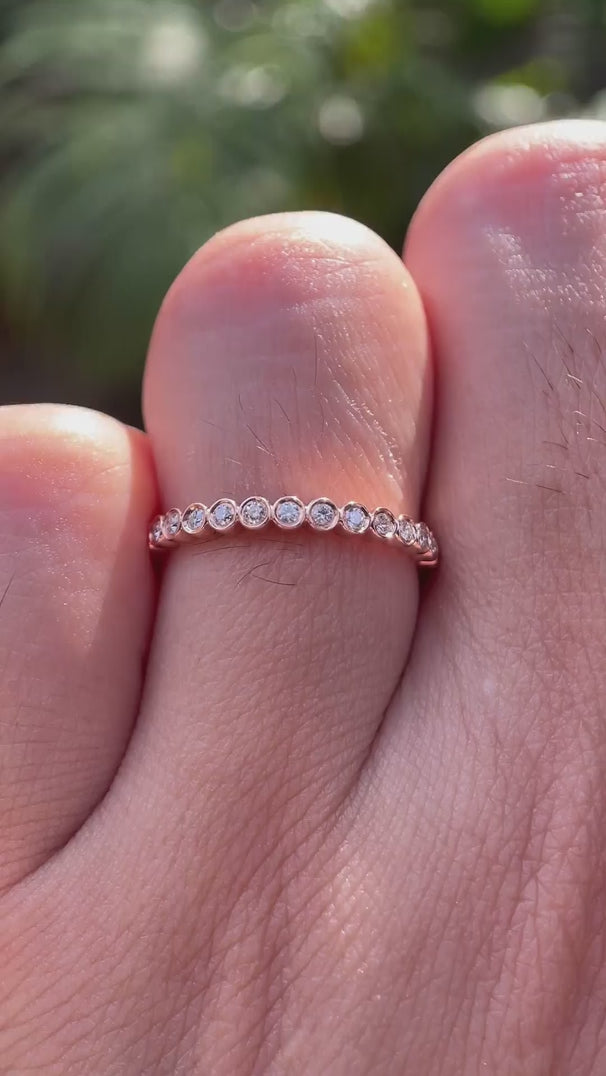 Rotating view of slim bezel set moissanite half eternity ring