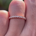 Rotating view of slim bezel set moissanite half eternity ring