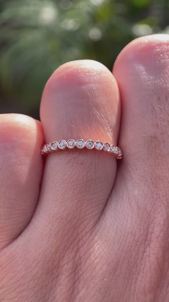 Rotating view of slim bezel set moissanite half eternity ring