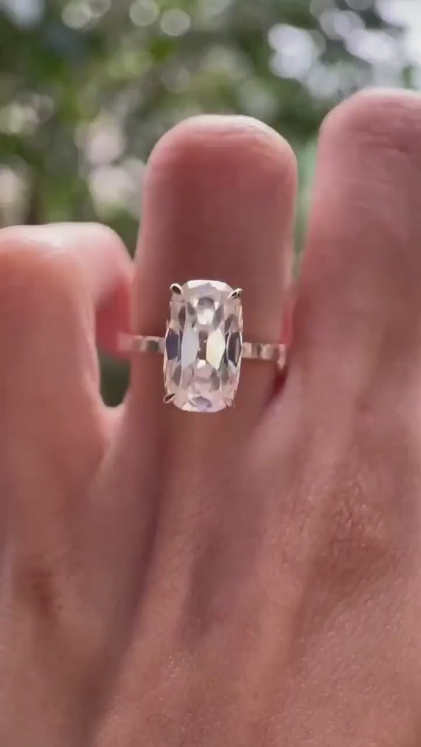 Elongated cushion moissanite ring with accent stone rotating view