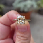 Elongated cushion old mine cut light champagne moissanite solitaire ring in 10K yellow gold rotating view