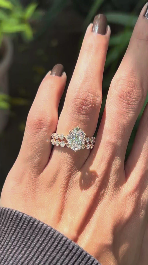 Close rotating view of on hand oval lab diamond ring with stacked diamond band 