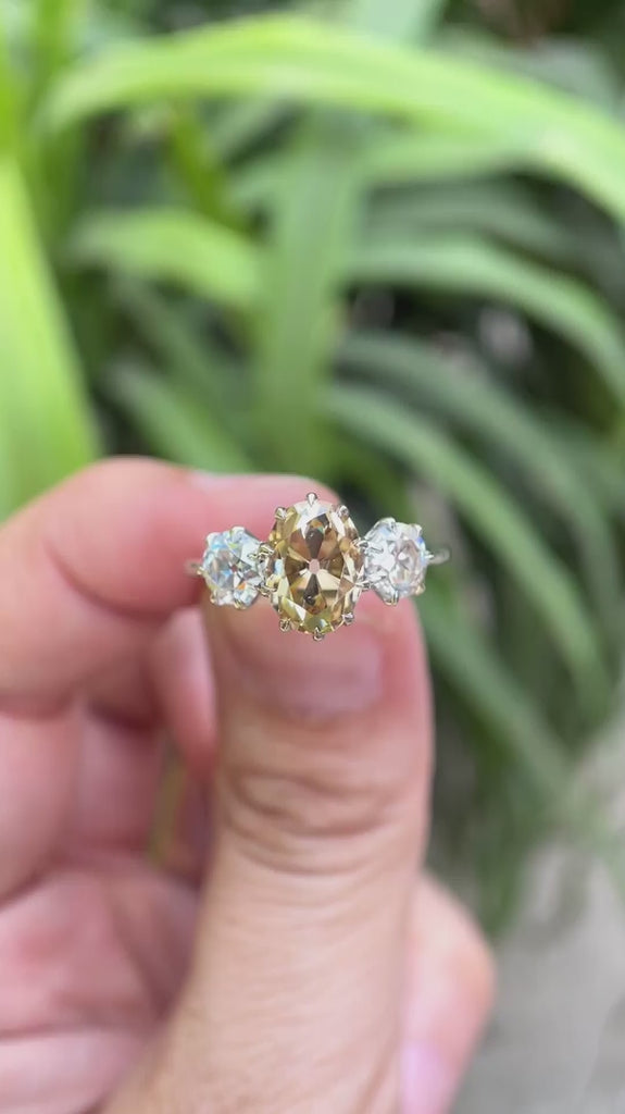 Oval old mine cut champagne moissanite ring with round side stones video