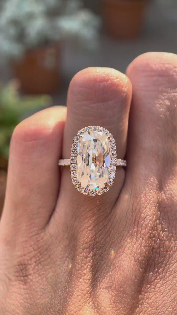 Elongated cushion old mine cut moissanite halo engagement ring with pavé band in 10K yellow gold shown in rotating video