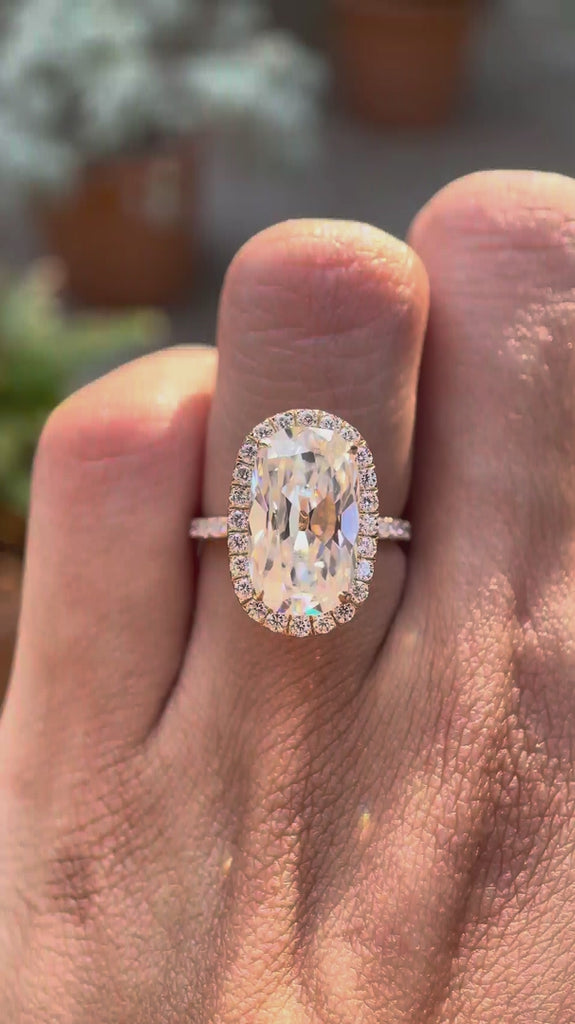 Elongated cushion old mine cut moissanite halo engagement ring with pavé band in 10K yellow gold shown in rotating video