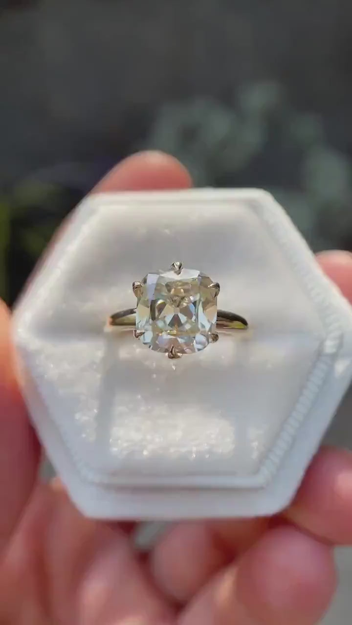 Elongated cushion Old Mine cut moissanite solitaire ring in 14K yellow gold rotating view highlighting faceting and setting detail