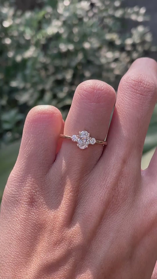 Oval moissanite three stone ring with round side stones video