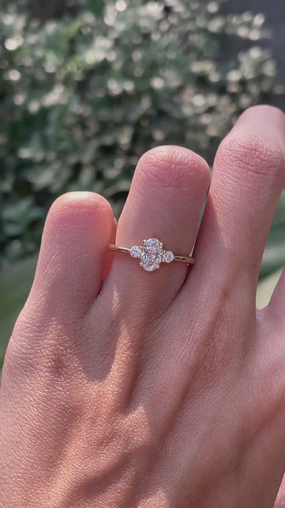 Oval moissanite three stone ring with round side stones video