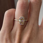 Video shows an oval dark champagne half bezel floating ring rotating view.