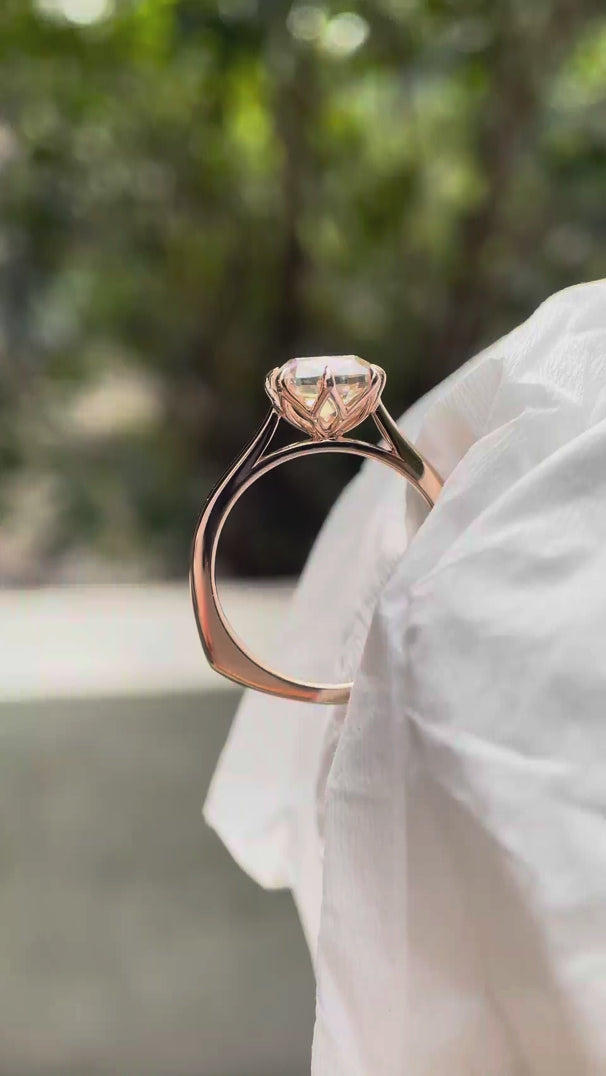 Elongated cushion Old Mine Cut moissanite solitaire engagement ring in 14K rose gold rotating view showing six-prong setting and band profile