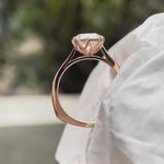 Elongated cushion Old Mine Cut moissanite solitaire engagement ring in 14K rose gold rotating view showing six-prong setting and band profile