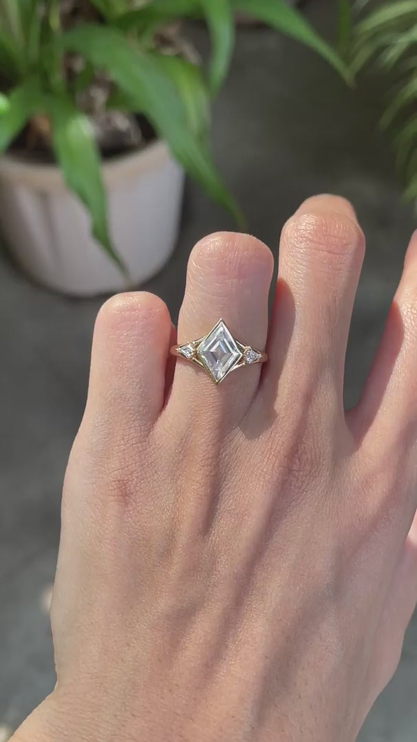 Lozenge cut moissanite trilogy engagement ring, kite side stones, 14k yellow gold