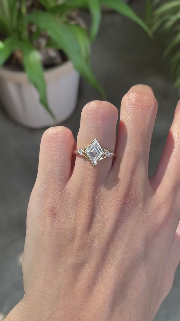 Lozenge cut moissanite trilogy engagement ring, kite side stones, 14k yellow gold