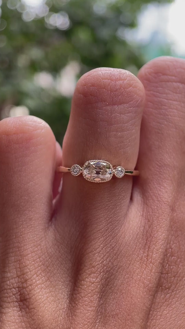 Elongated cushion old mine cut moissanite three stone engagement ring with milgrain bezel in 10K yellow gold shown in rotating video